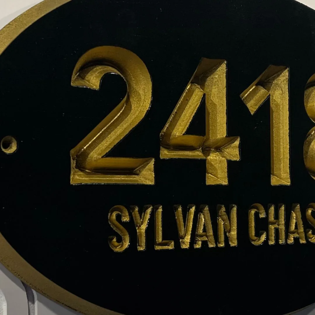 2418 Sylvan Chase oval address sign in gold on black