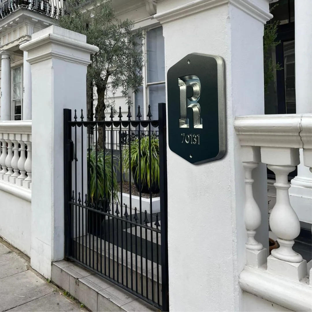 R monogram plaque on a gate pillar beside white balusters