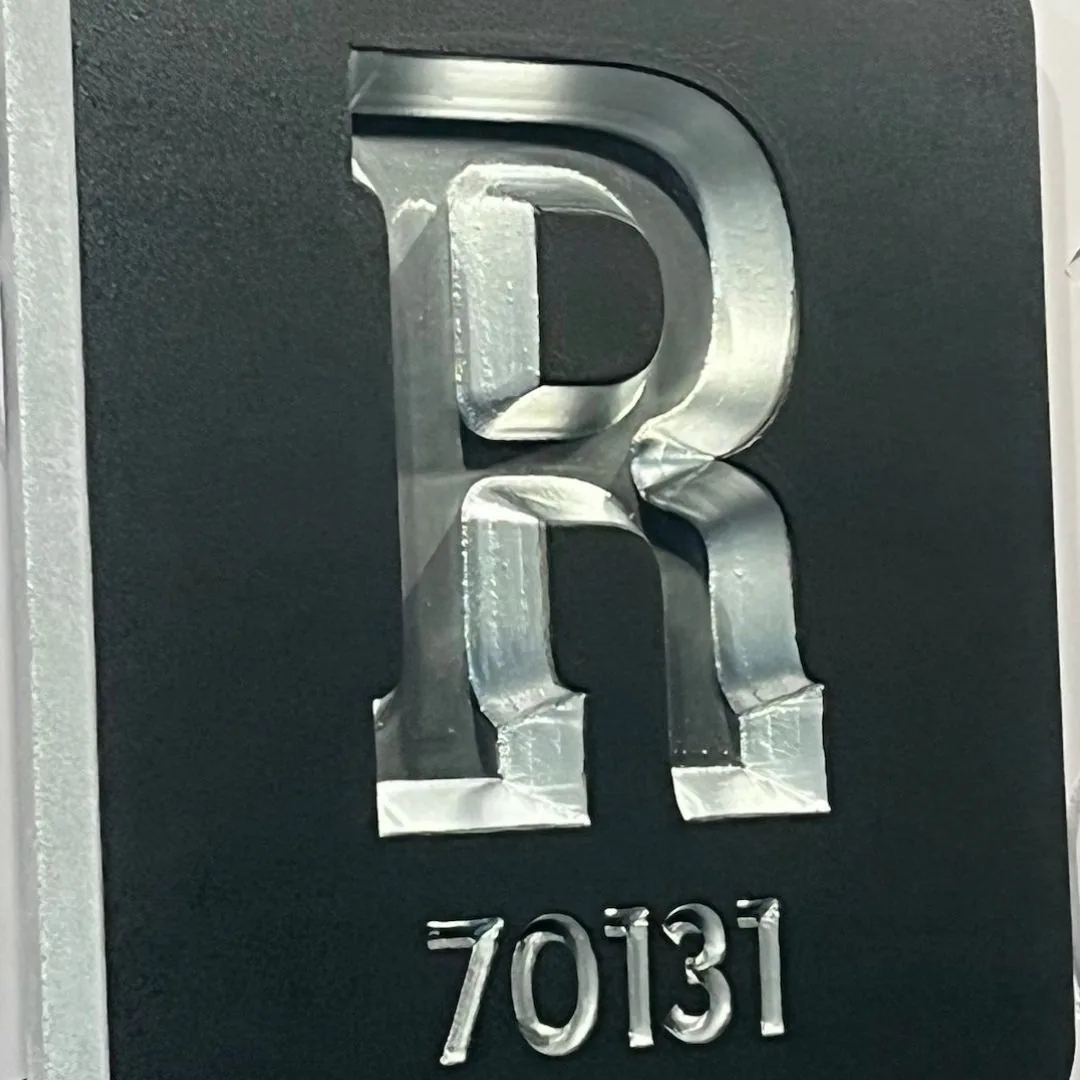 R 70131 home plaque in silver on black on a gate pillar