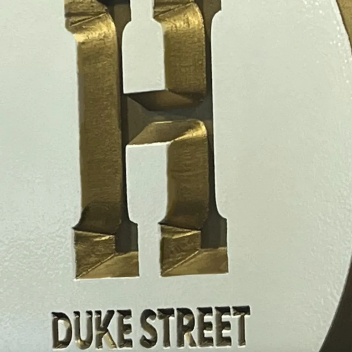 H Duke Street house plaque beside an arched navy door