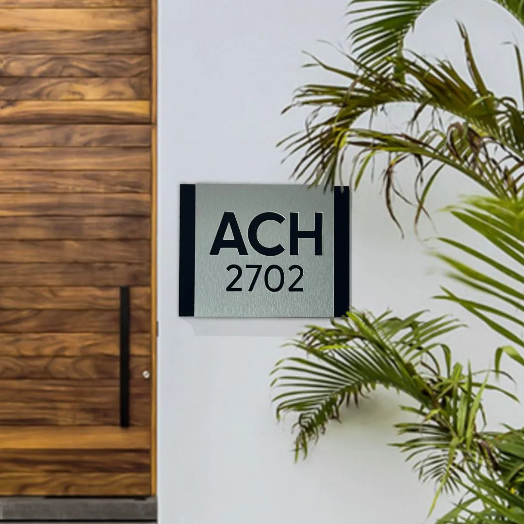 ACH 2702 modern house sign in brushed aluminum by a wood door