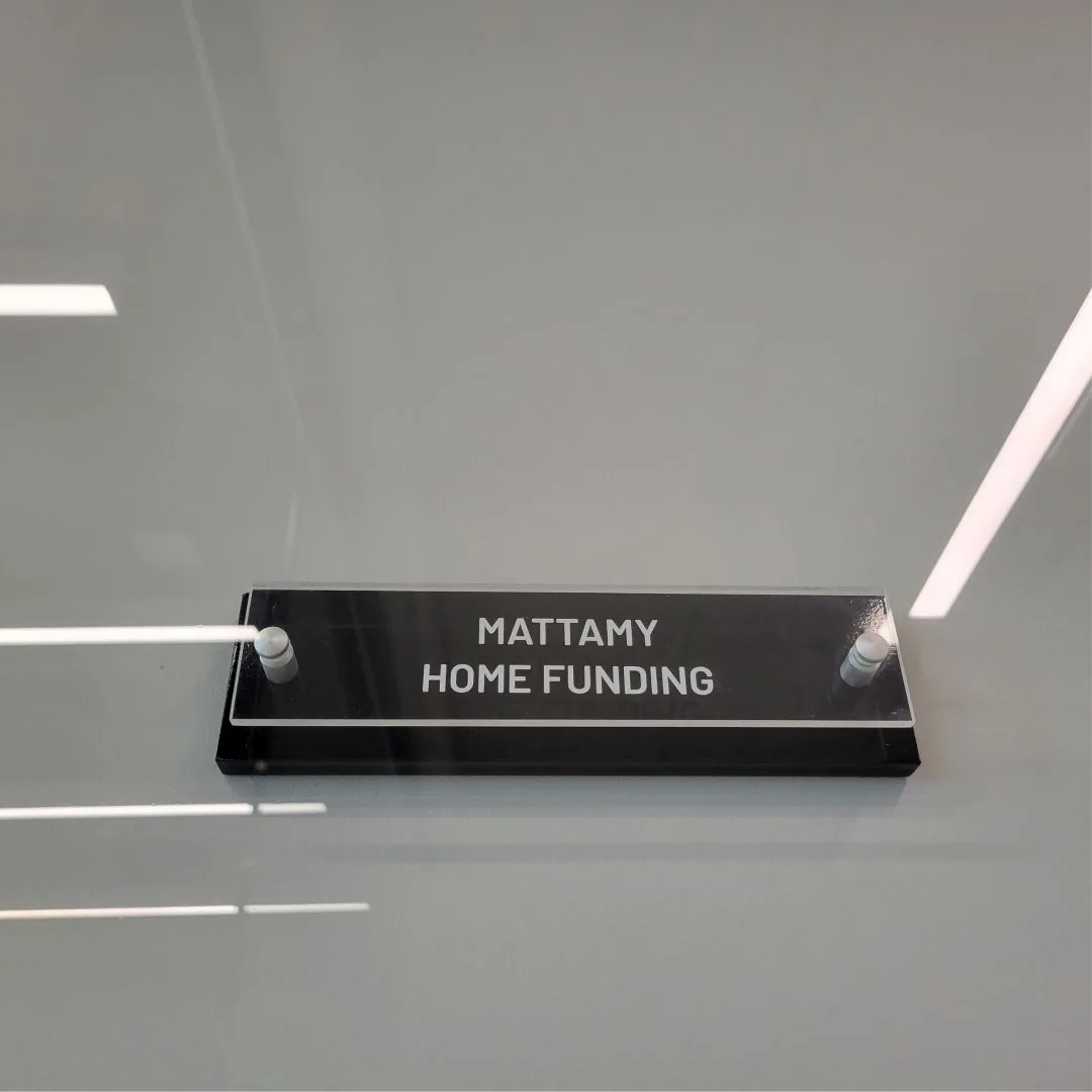 Acrylic department sign reading Mattamy Home Funding with brushed aluminum standoffs