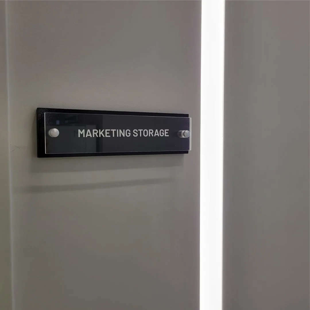 Acrylic room sign reading Marketing Storage