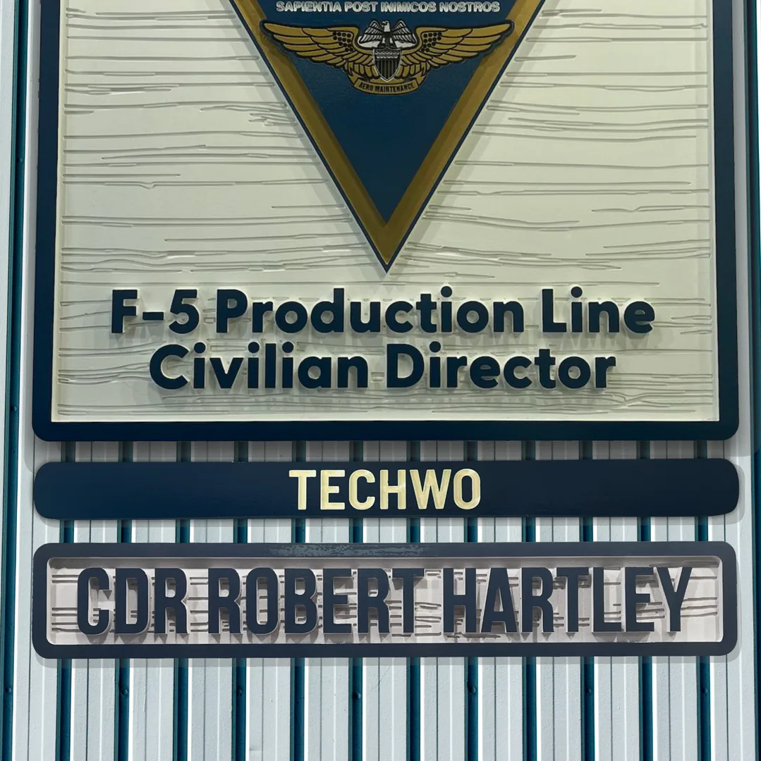 Routed Fleet Readiness Center crest with a title sign reading TECHWO and a name sign reading CDR Robert Hartley beneath it