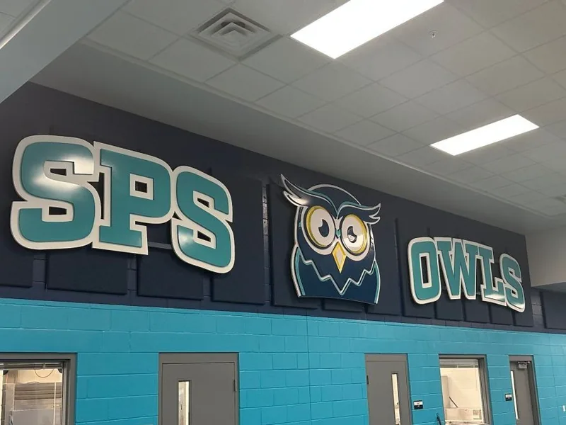 SPS Owls cafeteria wall graphics above the serving windows, by Brand 9 Signs