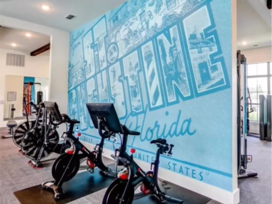 Full-wall printed St. Augustine, Florida postcard mural in a community fitness room, by Brand 9 Signs